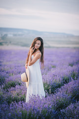 Fototapeta na wymiar Beautiful young woman posing in a lavender field
