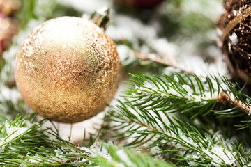 Gold Christmas ornament on leaves