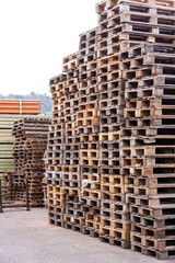 Stacks of old wooden pallets in a yard