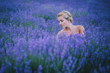 Beautiful young girl posing in a lavender field