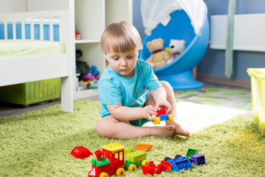 child boy playing with construction toys indoor