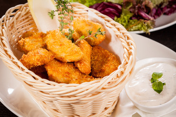 Crumbed chicken nuggets in a basket