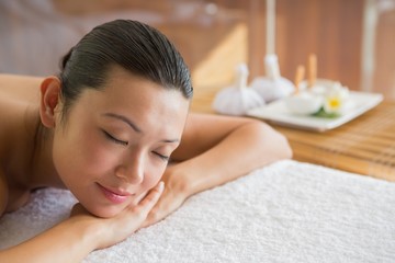 Obraz na płótnie Canvas Content brunette relaxing on massage table