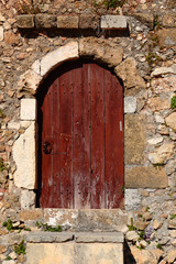 Fototapeta na wymiar Weathered door on the old town of Chania, Crete island
