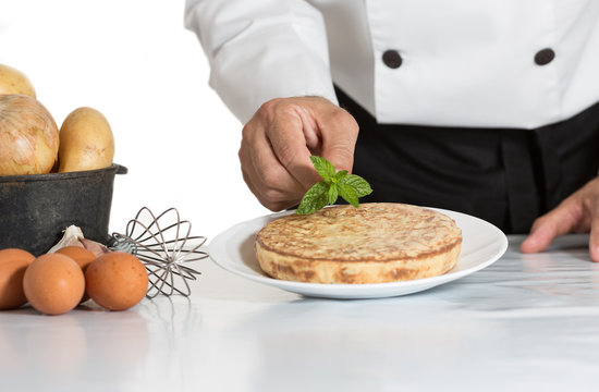 Chef Decorating A Potato Omelette