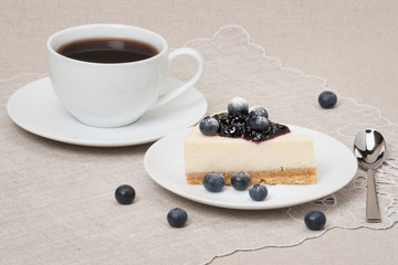 Cheese Cake With Blueberry Jam And Blueberries On White Plate