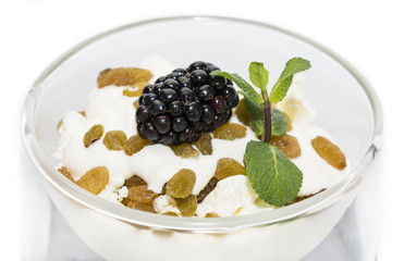 cottage cheese with sour cream and raisins on a white background