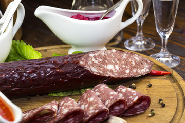 sausages on a wooden plate with vegetables in a restaurant