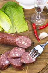 sausages on a wooden plate with vegetables in a restaurant