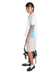 Young Asian school girl with backpack in school uniform