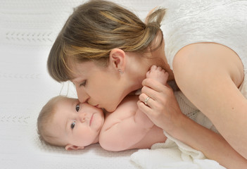 Obraz na płótnie Canvas mother kissing baby with love