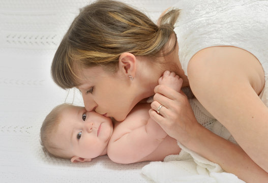 mother kissing baby with love