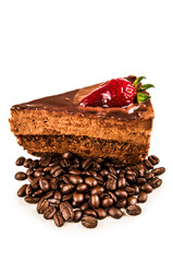 chocolate cake with spilled cofee beans and strawberry on top