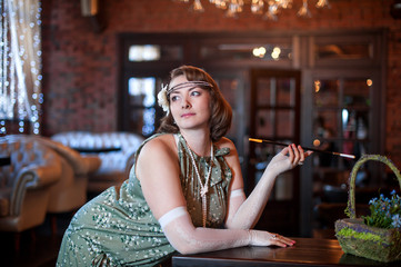 Woman in vintage dress smoking cigarette in restaurant