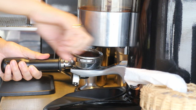 Barista Making Ground Coffee With Coffee Grinder