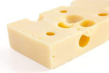Block of swiss type cheese on white
