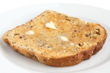 Slice of multi-seed wholegrain bread toasted and buttered