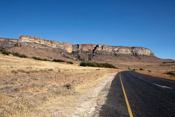 Curved Rural Road with Panoramic View of Mountains