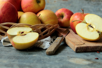 Red apples. Sliced apple on cutting board.