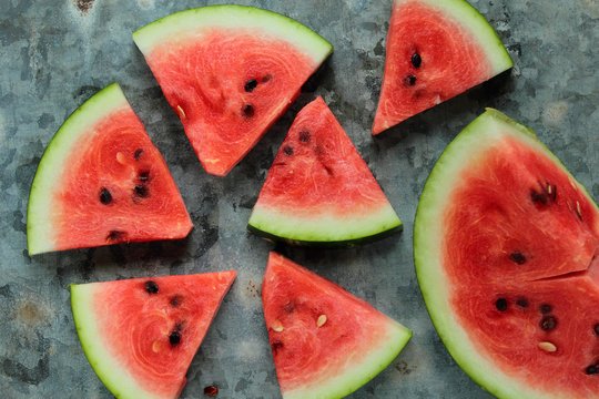 Fresh watermelon pieces on a metal board