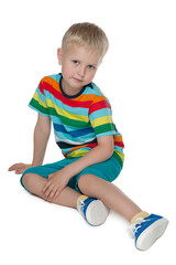 Pensive little boy in the bright shirt