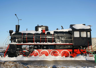 old steam locomotive in the snow black and red