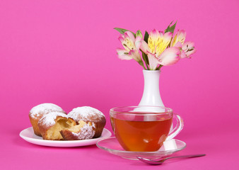 Cupcakes, tea and flowers in a vase