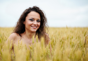 Happy young woman in wheat field