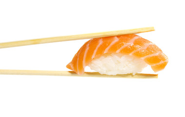 Salmon sushi nigiri in chopsticks isolated on white background