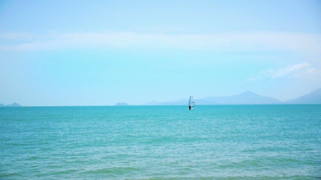 Windsurfing on a Clear Day in a Blue Sea. Thailand.
