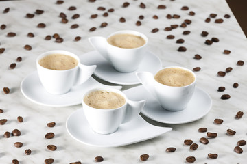 Obraz na płótnie Canvas four cups of coffee with milk