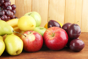 Composition of different fruits on table on wooden background