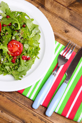 Green salad made with  arugula, tomatoes and sesame