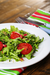 Green salad made with  arugula, tomatoes and sesame