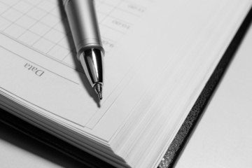 Pen on opened book, close up