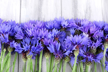 Beautiful cornflowers on wooden background