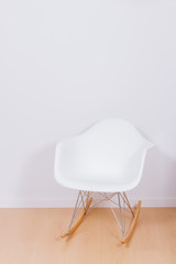 Modern white rocking chair and wall