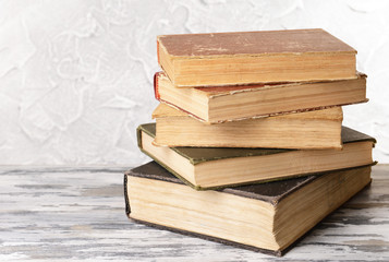 Old books on table on grey background