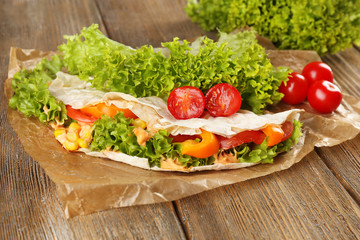 Veggie wrap filled with chicken and fresh vegetables