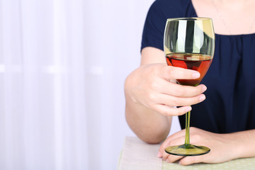 Young woman with glass of red wine