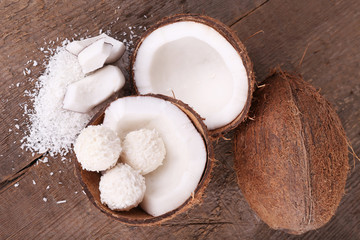 Broken coconut on wooden background