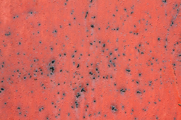 red painted metal with rusty spots