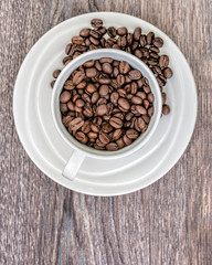 Cup with coffee beans, close up