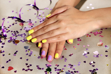 Obraz na płótnie Canvas Female hand with stylish colorful nails, on bright background