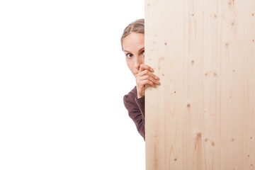 Woman behind a wooden board