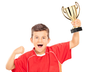 Overjoyed boy holding a gold cup