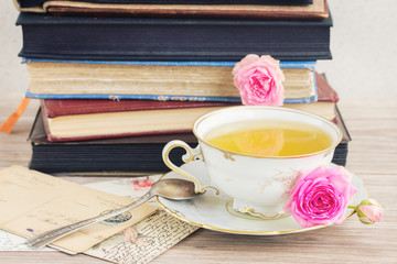 old books and mail with cup of tea