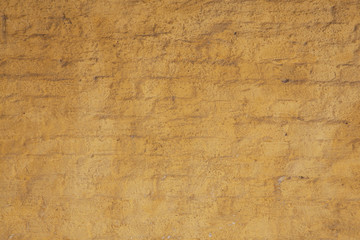 part of old ochre painted brick wall