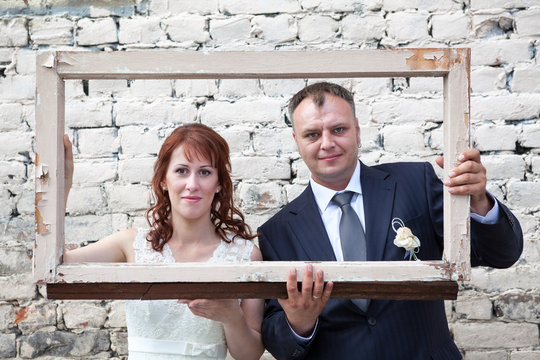 Faces of bride and groom in portrait frame