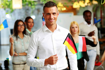Smiling businessman holding flag of Germany